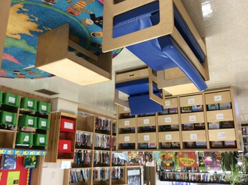 Child size couch, chairs and tables with bookshelves, book drawers and book bins 